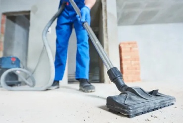 Cleaner vacuuming the floor