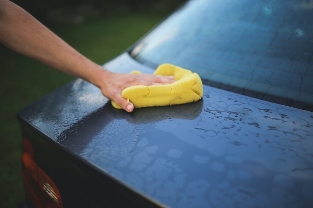 Cleaning car with sponge