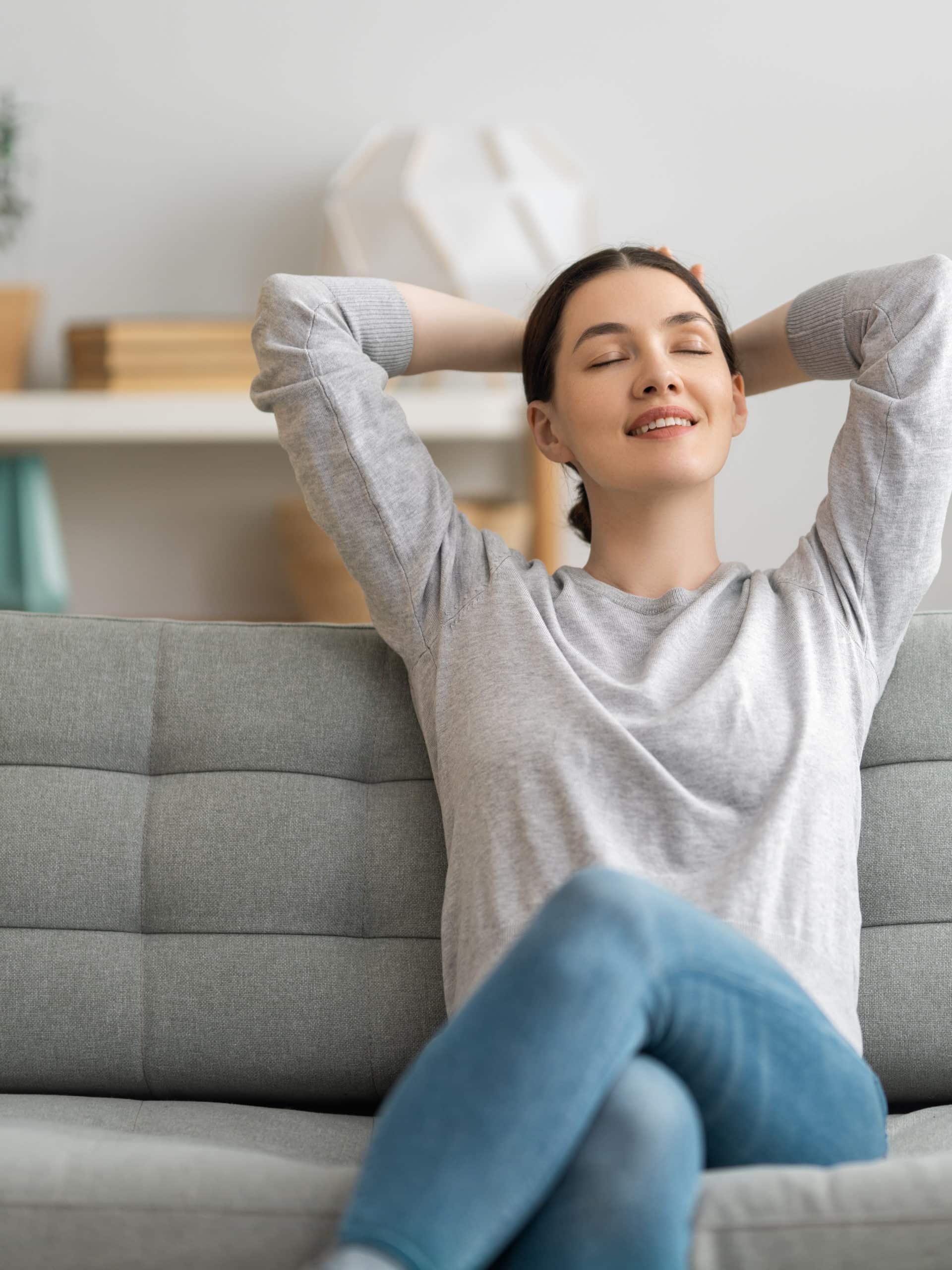 Portrait of beautiful woman resting on sofa at home