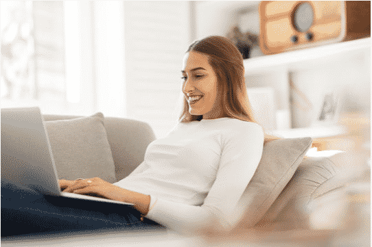 Female using laptop on couch