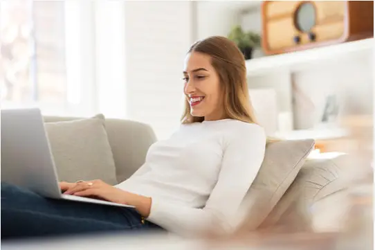 Female using laptop on couch