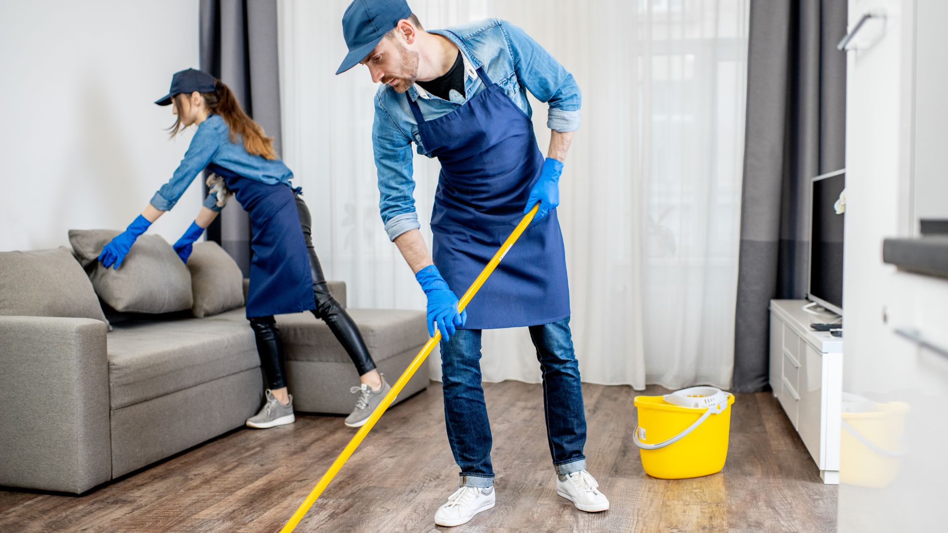 2 cleaners cleaning a living room