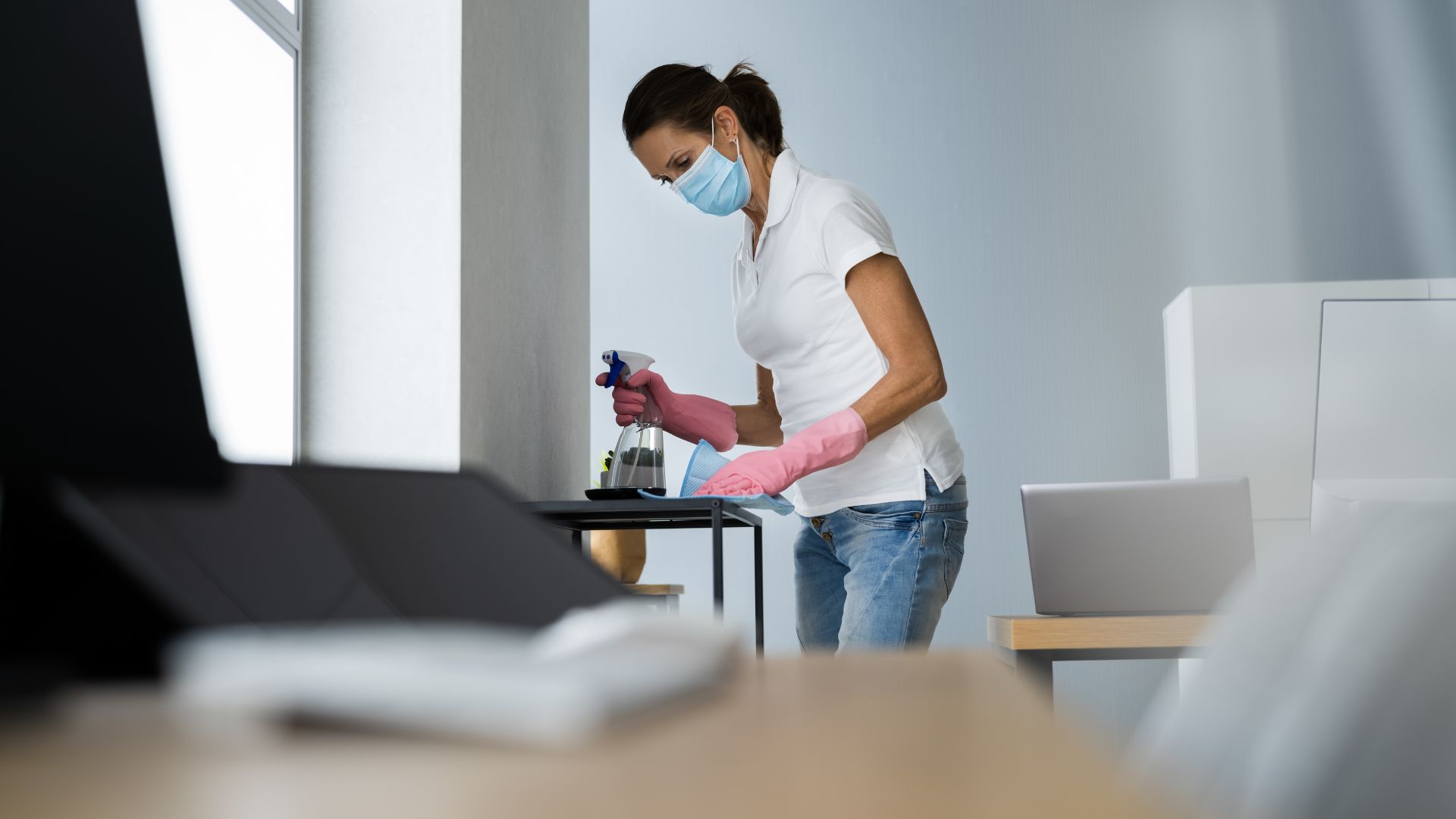Maid cleaning a rack in an office
