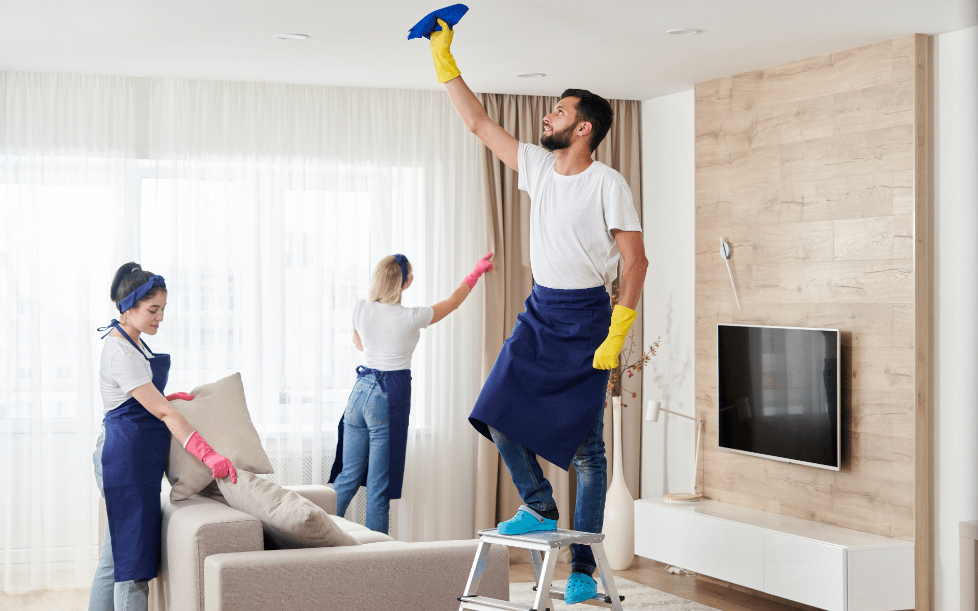 3 maids cleaning living room