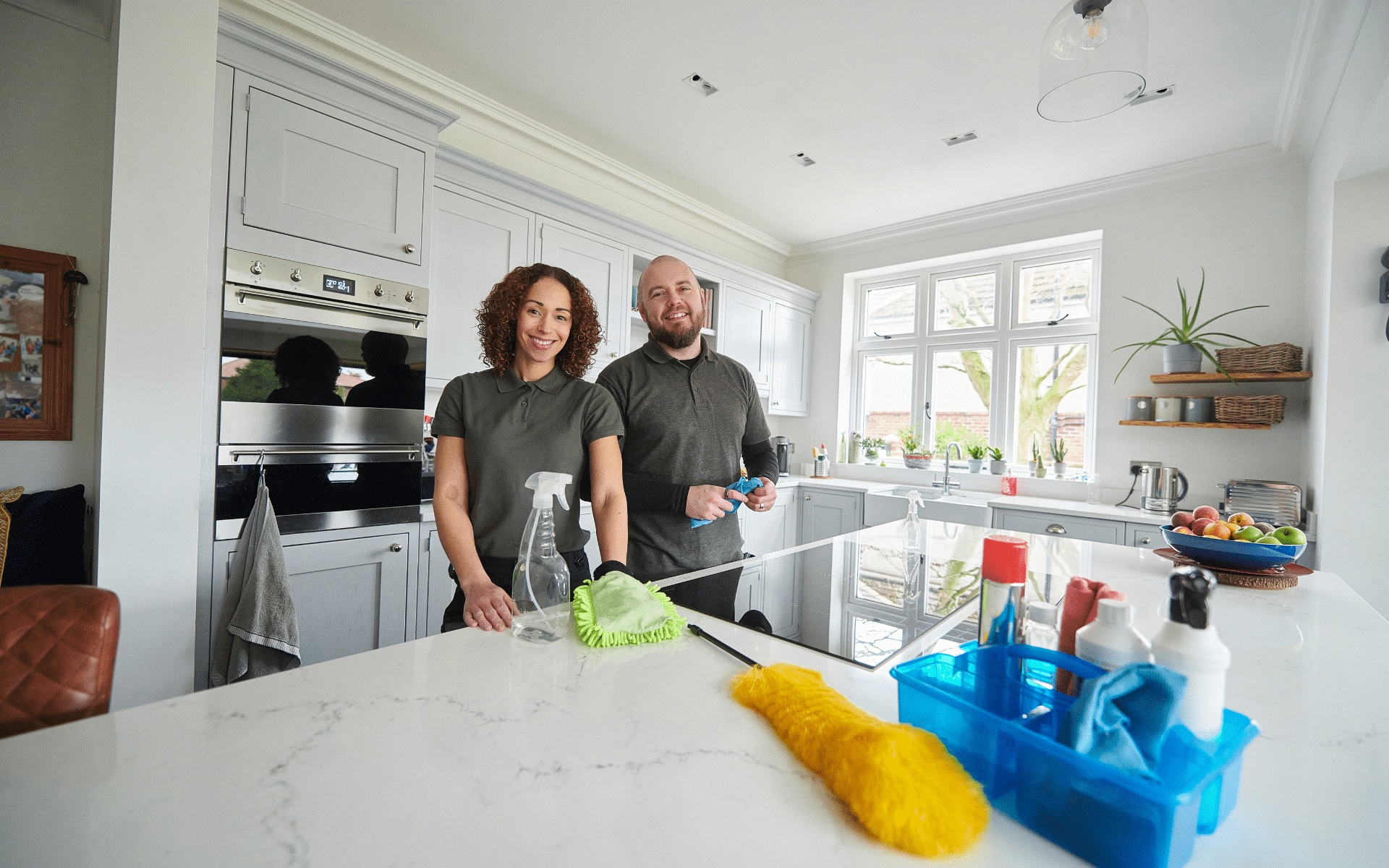 2 maids cleaning apartment kitchen